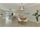 Open concept dining room with view into living room and kitchen at 9847 Haze Dr, Venice, FL 34292