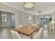 Light and airy dining area with wood table at 9847 Haze Dr, Venice, FL 34292