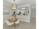 Elegant dining area with a wooden table and neutral decor, open to the kitchen at 9847 Haze Dr, Venice, FL 34292