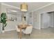 Open concept dining room with wooden table and chairs, adjacent to the kitchen at 9847 Haze Dr, Venice, FL 34292