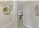 Bright entryway with decorative mirrors and wall art leading to the kitchen at 9847 Haze Dr, Venice, FL 34292