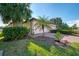 Landscaped home exterior with palm trees at 9847 Haze Dr, Venice, FL 34292