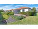 Home exterior showcasing a well-manicured lawn and brick pavers at 9847 Haze Dr, Venice, FL 34292