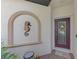 Front entry with decorative seahorse and wreath at 9847 Haze Dr, Venice, FL 34292