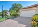 White double garage door with paver driveway at 9847 Haze Dr, Venice, FL 34292