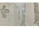 Light and airy hallway with wall art, showcasing the home's neutral color palette at 9847 Haze Dr, Venice, FL 34292