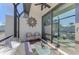 Covered lanai with seating and glass doors leading to the backyard at 9847 Haze Dr, Venice, FL 34292