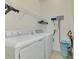 Bright laundry room with washer, dryer, and ample shelving at 9847 Haze Dr, Venice, FL 34292