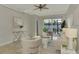 Spacious living room with neutral decor, access to a patio, and a ceiling fan at 9847 Haze Dr, Venice, FL 34292