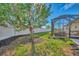Landscaped backyard with a tree and privacy fence at 9855 Haze Dr, Venice, FL 34292