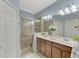 Elegant bathroom with double vanity, shower, and modern finishes at 9855 Haze Dr, Venice, FL 34292