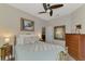 Charming bedroom with a full bed, dresser, and decorative mirror at 9855 Haze Dr, Venice, FL 34292