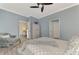 Serene bedroom with ceiling fan and access to other rooms at 9855 Haze Dr, Venice, FL 34292