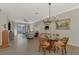 Elegant dining room with a glass-top table and chandelier at 9855 Haze Dr, Venice, FL 34292