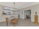 Dining room with glass-top table and kitchen passthrough at 9855 Haze Dr, Venice, FL 34292