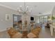 Open concept dining room with chandelier and living room access at 9855 Haze Dr, Venice, FL 34292