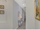 Bright hallway with decorative wall niches and hardwood floors at 9855 Haze Dr, Venice, FL 34292