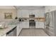 Modern kitchen with stainless steel appliances and granite countertops at 9855 Haze Dr, Venice, FL 34292