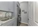 Laundry room with stackable washer/dryer and granite countertop at 9855 Haze Dr, Venice, FL 34292