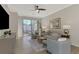 Living room features a large TV, comfy seating, and patio access at 9855 Haze Dr, Venice, FL 34292