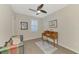Home office featuring a writing desk, comfy seating, and wood floors at 9855 Haze Dr, Venice, FL 34292