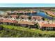 Aerial view showing a single unit in a large community by a lake at 10055 Crooked Creek Dr # 102, Venice, FL 34293