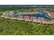 Aerial view showing a single unit in a large community by a lake at 10055 Crooked Creek Dr # 102, Venice, FL 34293