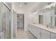 Elegant bathroom with double vanity, quartz countertop and walk-in shower at 10055 Crooked Creek Dr # 102, Venice, FL 34293