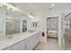 Spa-like bathroom with double vanity and walk-in shower at 10055 Crooked Creek Dr # 102, Venice, FL 34293