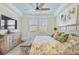 Bright bedroom with king bed, dresser, and large windows at 10055 Crooked Creek Dr # 102, Venice, FL 34293