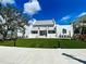 Community clubhouse with a lush green lawn at 10055 Crooked Creek Dr # 102, Venice, FL 34293