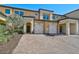 Front view of townhome with landscaping and paver driveway at 10055 Crooked Creek Dr # 102, Venice, FL 34293