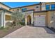 Townhome exterior showcasing landscaping and paver driveway at 10055 Crooked Creek Dr # 102, Venice, FL 34293