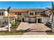 Luxury townhouses with brick driveways, garages, and lush landscaping at 10055 Crooked Creek Dr # 102, Venice, FL 34293