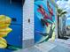 Building exterior with vibrant mural featuring flowers and butterfly at 10055 Crooked Creek Dr # 102, Venice, FL 34293