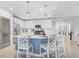 Modern kitchen with white cabinets, island, and stainless steel appliances at 10055 Crooked Creek Dr # 102, Venice, FL 34293