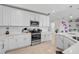 Modern kitchen with white cabinets and stainless steel appliances at 10055 Crooked Creek Dr # 102, Venice, FL 34293