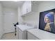 Convenient laundry room with washer, dryer, and ample storage at 10055 Crooked Creek Dr # 102, Venice, FL 34293