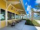 Outdoor patio with tables and chairs, offering waterfront views at 10055 Crooked Creek Dr # 102, Venice, FL 34293