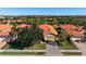 Aerial view of a community with houses and landscaping at 115 Avalini Way, North Venice, FL 34275