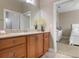 Bathroom with wood cabinets and a granite countertop at 115 Avalini Way, North Venice, FL 34275