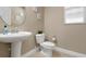 Small bathroom with pedestal sink and toilet at 115 Avalini Way, North Venice, FL 34275