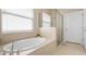 Relax in this spa-like bathroom, featuring a large soaking tub and a separate shower at 115 Avalini Way, North Venice, FL 34275