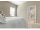 Bright bedroom with a queen-size bed and access to a closet at 115 Avalini Way, North Venice, FL 34275