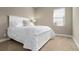 Comfortable bedroom with a white bed frame and ample natural light at 115 Avalini Way, North Venice, FL 34275