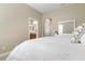 Main bedroom with a plush bed, access to the bathroom, and closet at 115 Avalini Way, North Venice, FL 34275