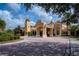 Gated community entrance with a grand, Mediterranean-style building at 115 Avalini Way, North Venice, FL 34275