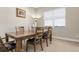 Spacious dining room with a large wooden table and six chairs at 115 Avalini Way, North Venice, FL 34275