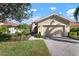 Tan house with a two-car garage and walkway at 115 Avalini Way, North Venice, FL 34275