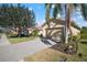 Tan house with a two-car garage and landscaping at 115 Avalini Way, North Venice, FL 34275
